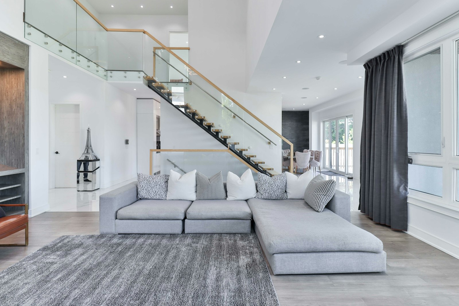 Bright, tidy living room with grey sofa and rug after home cleaning services in Dubai
